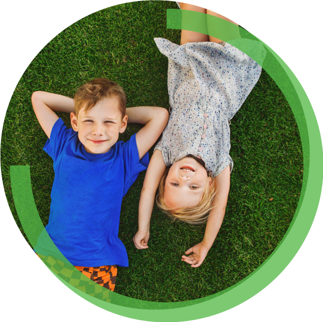 Two Kids laying on synthetic turf